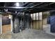 View of the unfinished basement with exposed pipes and concrete flooring at 2828 N Moreland Ave, Indianapolis, IN 46222