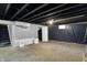View of unfinished basement with stair access, vapor barrier, and mechanical features at 2828 N Moreland Ave, Indianapolis, IN 46222