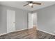 Bedroom with wood-look flooring, gray walls, a ceiling fan, and an open doorway at 2828 N Moreland Ave, Indianapolis, IN 46222