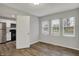 Bedroom with wood-look floors with a kitchen visible through doorway at 2828 N Moreland Ave, Indianapolis, IN 46222