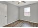 Bedroom with modern gray walls, wood-look flooring, and a bright window at 2828 N Moreland Ave, Indianapolis, IN 46222