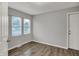 A simple room features wood-look floors and two windows at 2828 N Moreland Ave, Indianapolis, IN 46222