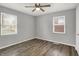 Bedroom with wood-look flooring, gray walls, windows, and natural light at 2828 N Moreland Ave, Indianapolis, IN 46222