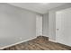 Bedroom with neutral walls, wood-look floors and multiple doors at 2828 N Moreland Ave, Indianapolis, IN 46222