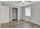 Bedroom with wood-look flooring, a ceiling fan, a window, and a closet at 2828 N Moreland Ave, Indianapolis, IN 46222