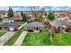 An aerial view shows a well-maintained red brick home with a concrete driveway and a lush green lawn at 2828 N Moreland Ave, Indianapolis, IN 46222