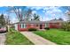 Charming single-story brick home with a well-manicured front lawn and a paved driveway at 2828 N Moreland Ave, Indianapolis, IN 46222
