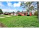 Well-maintained brick home with a lush green lawn and inviting curb appeal at 2828 N Moreland Ave, Indianapolis, IN 46222