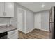 Modern kitchen offers white cabinets, stainless appliances, and wood-look floors at 2828 N Moreland Ave, Indianapolis, IN 46222