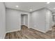 Neutral living room boasts recessed lighting and wood-look floors at 2828 N Moreland Ave, Indianapolis, IN 46222