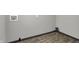 Utility room featuring wood-look floors and gray walls with paint cans on floor at 2828 N Moreland Ave, Indianapolis, IN 46222