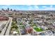 An aerial photograph showing colorful homes in a neighborhood bordering a cityscape with tall buildings under a blue sky at 305 Sanders St, Indianapolis, IN 46225