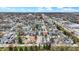 A wide aerial view of a residential neighborhood featuring colorful homes, a nearby parking lot, and an open blue sky at 305 Sanders St, Indianapolis, IN 46225