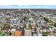 An elevated perspective captures a neighborhood with a mix of homes, streets, and commercial spaces beneath a cloudy sky at 305 Sanders St, Indianapolis, IN 46225