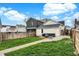 Landscaped backyard featuring a walkway, patio, seating, and well-maintained lawn at 305 Sanders St, Indianapolis, IN 46225