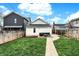Manicured backyard featuring a walkway, patio, seating, and lush, green lawn at 305 Sanders St, Indianapolis, IN 46225