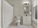 Bright bathroom featuring a white vanity, modern fixtures, and a shower with a neutral colored shower curtain at 305 Sanders St, Indianapolis, IN 46225