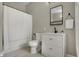 A modern bathroom with a sleek vanity, elegant mirror, and a shower with curtains, beautifully designed at 305 Sanders St, Indianapolis, IN 46225