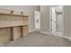 An empty bedroom with an attached bathroom, a built-in shelving unit, and neutral colored walls at 305 Sanders St, Indianapolis, IN 46225