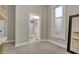 A bedroom with a window, an open bathroom door, and built-in shelving, with neutral paint at 305 Sanders St, Indianapolis, IN 46225