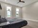 Comfortable bedroom with a platform bed, bright windows, and a ceiling fan, great for relaxation at 305 Sanders St, Indianapolis, IN 46225