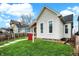 Features a lush green lawn and a classic white facade that enhances its curb appeal at 305 Sanders St, Indianapolis, IN 46225