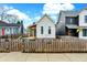 Features a charming front yard, complemented by a picket fence and neighboring houses at 305 Sanders St, Indianapolis, IN 46225