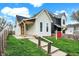 An eye-level shot shows a well-manicured lawn and inviting entrance to this cozy home at 305 Sanders St, Indianapolis, IN 46225