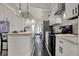 This modern kitchen features white cabinets, stainless steel appliances, and an island with seating at 305 Sanders St, Indianapolis, IN 46225