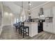 Modern kitchen showcases stainless steel appliances, sleek white cabinetry, and an island with seating at 305 Sanders St, Indianapolis, IN 46225