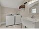 Functional laundry room features a sink, and washer and dryer for added convenience at 305 Sanders St, Indianapolis, IN 46225