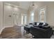 Spacious living room boasts high ceilings, contemporary lighting, and stylish gray furniture at 305 Sanders St, Indianapolis, IN 46225