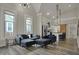 Open floor plan living room connected to a kitchen with modern gray furniture and natural light at 305 Sanders St, Indianapolis, IN 46225