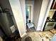 Hallway from kitchen shows water heater, and connections to other rooms in house at 3536 N Hawthorne Ln, Indianapolis, IN 46218