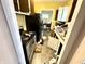 Unorganized kitchen view shows stainless steel appliances, view into adjacent dining room at 3536 N Hawthorne Ln, Indianapolis, IN 46218