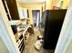 View of kitchen with black refrigerator, stainless steel sink, and wood cabinets at 3536 N Hawthorne Ln, Indianapolis, IN 46218