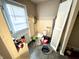 Mud room with white door and disorganized accessories and appliances at 3536 N Hawthorne Ln, Indianapolis, IN 46218