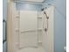 Accessible bathroom featuring a walk-in shower with safety bars and adjustable shower head, ensuring comfort and ease of use at 36 Palomino Ct, Zionsville, IN 46077