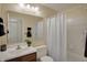 A bathroom featuring a large mirror, tile flooring, and shower-tub combo at 36 Palomino Ct, Zionsville, IN 46077