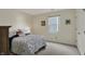 A bedroom featuring natural light from a window and neutral carpet at 36 Palomino Ct, Zionsville, IN 46077