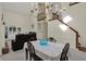 Elegant dining area with a chandelier, staircase and a view of the living room at 36 Palomino Ct, Zionsville, IN 46077