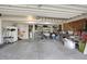 Spacious garage providing ample storage with shelving and overhead racks for organization; perfect for hobbies and projects at 36 Palomino Ct, Zionsville, IN 46077