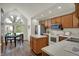 Bright kitchen with stainless steel appliances, oak cabinetry, and adjacent breakfast nook at 36 Palomino Ct, Zionsville, IN 46077