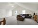 A relaxing living room featuring an L-shaped couch and two windows at 36 Palomino Ct, Zionsville, IN 46077