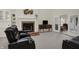 Cozy living room with a brick fireplace, built-in shelving, and comfortable leather seating at 36 Palomino Ct, Zionsville, IN 46077
