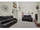 Open-concept living area with high ceilings, a fireplace, and comfortable leather seating at 36 Palomino Ct, Zionsville, IN 46077