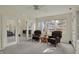 A sun room with cozy seating, windows, and sliding glass door at 36 Palomino Ct, Zionsville, IN 46077
