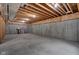 Unfinished basement with concrete floor and exposed ceiling, ready for customization and storage at 3748 Pawnee Trl, Columbus, IN 47203