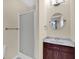Well-lit bathroom featuring a shower, vanity with marble countertop, and round mirror at 3748 Pawnee Trl, Columbus, IN 47203