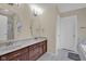 Bathroom featuring double sink vanity with marble countertops and updated fixtures at 3748 Pawnee Trl, Columbus, IN 47203